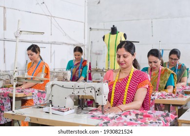 Indian Woman Textile Worker Using Sewing Machine On Production Line