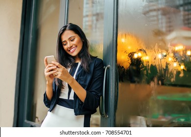 Indian Woman Texting On Her Phone 