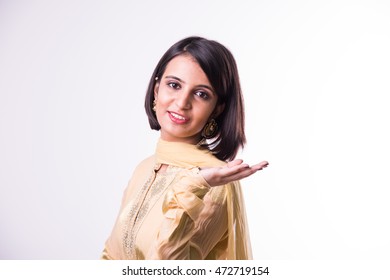 Indian woman in traditional clothing presenting, standing isolated over white background - Shutterstock ID 472719154