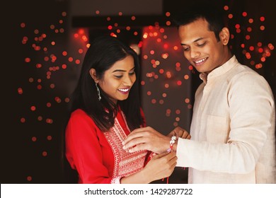 Indian woman tying rakhi on her brother's hand to celebrate Raksha Bandhan (Rakshabandhan) / Bhai dooj - Shutterstock ID 1429287722