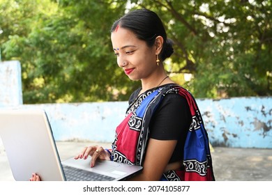 Indian woman using laptop and smartphone