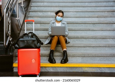 Indian Woman Wearing Face Mask Working With Laptop At Train Station Indoors