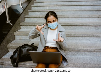 Indian Woman Wearing Face Mask Working With Laptop At Train Station Indoors