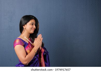 Indian Woman In Welcome Pose With Both Hands Folded In Namaskara Or Prayer Gesture. Copy Space
