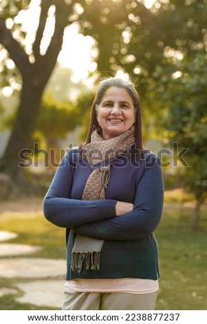 Indian woman in winter wear standing at park