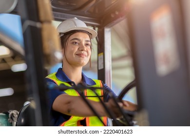 Indian woman worker warehouse forklift driver staff happy smiling enjoy working - Powered by Shutterstock