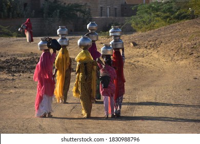 Indian Women Carrying Heavy Jugs Of Water On Their Head