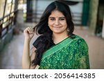 Indian women Face and she is in green saree - Stock Images