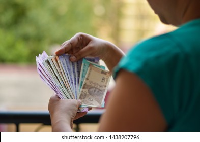 Indian Women Holding & Counting All The Colorful New Released Indian Rupees Currency Notes After Demonetisation In Denominations 10, Blue 50, Purple 100, Orange 200, Green 500, Pink 2000 In Her Hands