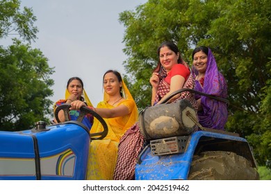 Indian women sitting on tractor - Shutterstock ID 2042519462