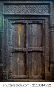 Indian Wooden Old Door Vintage Texture Background. Front View Of Ancient Mughal Art Door Doors Made Of Authentic Material In An Old Building Entrance. Weathered Wood Carved Door In India.