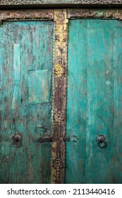 Indian Wooden Old Door Vintage Texture Background. Front View Of Ancient Mughal Art Door Doors Made Of Authentic Material In An Old Building Entrance. Weathered Wood Carved Door In India.