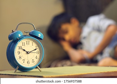 Indian Young Boy Sleeping With Alarm Clock	
