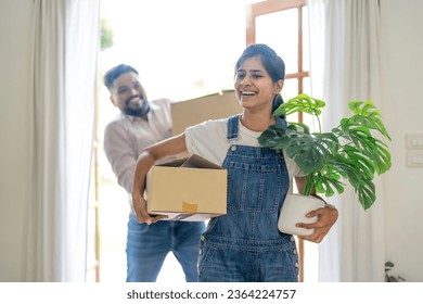 Indian young couple move the box into the home at new home. Relocation, moving to new home concept - Powered by Shutterstock