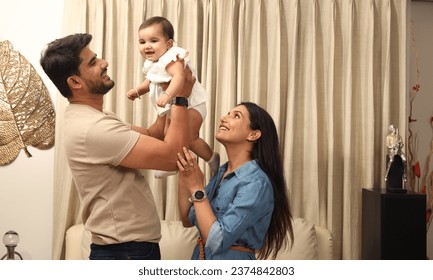  Indian young family with one infant child sitting on home. - Powered by Shutterstock