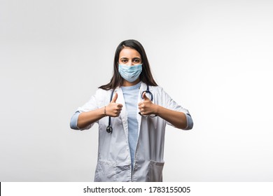 Indian Young Female Doctor With Uniform And Mask Showing Success Of Thumbs Up