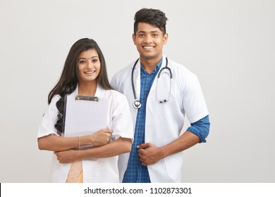 Indian Young Male And Female Doctor With Note Pad 