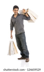 Indian Young Man With Shopping Bags On White Background.