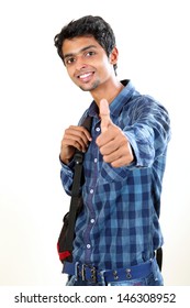 Indian young student carrying bag on white and  showing  thumbs up.