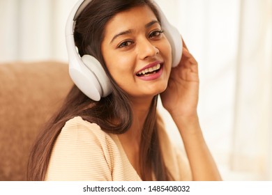 Indian young women enjoying music in headphones - Shutterstock ID 1485408032