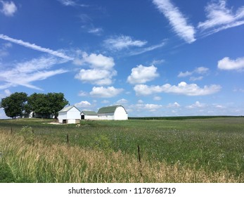 Indiana Farm With Green And White Barn Under A Blue Sky