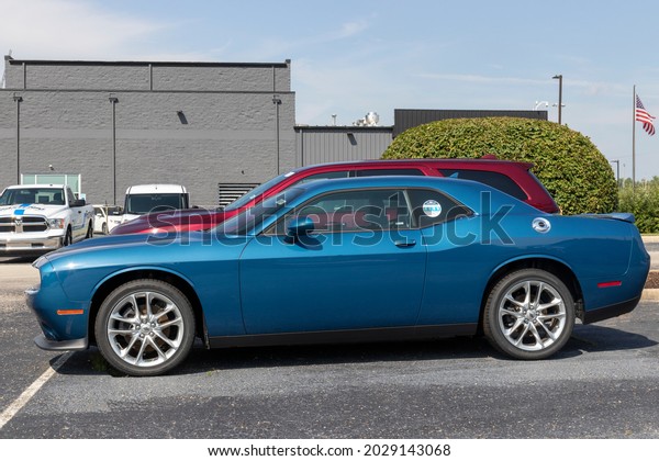 Indianapolis - Circa August 2021: Dodge Challenger\
display at a dealership. The Stellantis subsidiaries of FCA are\
Chrysler, Dodge, Jeep, and\
Ram.