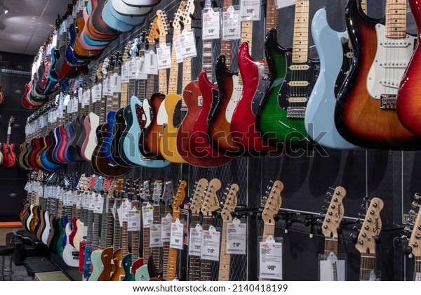 Indianapolis - Circa\
March 2022: Electric Guitar display at Guitar Center. Selling\
brands like Fender, Gibson and Ibanez, Guitar Center is a retailer\
of musical\
instruments.