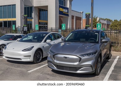 Indianapolis - Circa October 2021: CarMax Auto Dealership Tesla And Mustang Mach-E Display. CarMax Is The Largest Used And Pre-owned Car Retailer In The US.