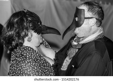 Indianapolis, Indiana / United States: October 21st, 2017: A Couple Lovebirds Dressed For A Masquerade Ball Huddle Close.