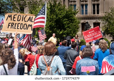 Indianapolis, Indiana, USA, May 1, 2020.  A group gathers at the state capital protesting the stay-at-home restrictions ordered by the governor to limit COVID-19 infections. 