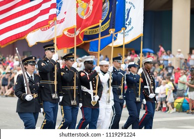 Indianapolis, Indiana, USA - May 26, 2018,  Members Of The US Military Carrying The American Flag Marching Down The Street During The Indy 500 Parade