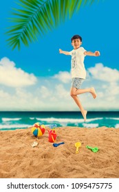 Indian/asian Boy Playing At Beach Sand With Toys And Ball