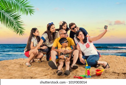 Indian/Asian Family Enjoying At Beach, Posing For Picture