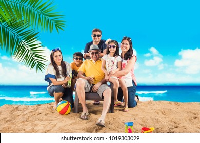 Indian/Asian Family Enjoying At Beach, Posing For Picture