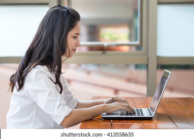 Indian,Asian Girl Student Working And Typing Laptop Computer.