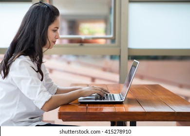 Indian,Asian Girl Student Working And Typing Laptop Computer.