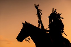 The Indians Are Riding A Horse And Spear Ready To Use In Light Of The Silhouette