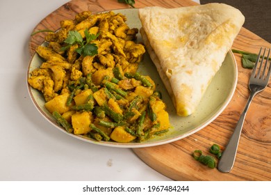 Indian-surinamese spicy food lunch and dinner roti chicken curry meal 