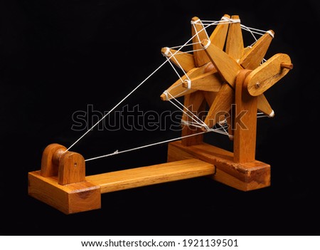 India's famous spinning wheel called charkha of mahatma gandhi on black background selective focus