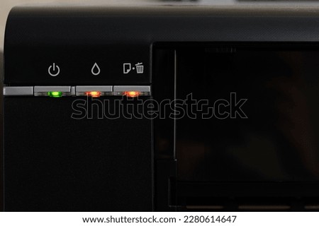 The indicators on the printer are red, the printer is broken, close-up. Multifunctional printer device.Office equipment.Professional printer service.