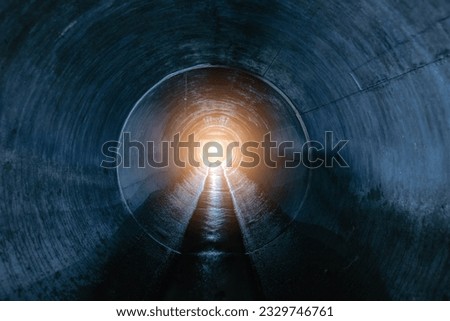 Indide dark round underground sewer tunnel.
