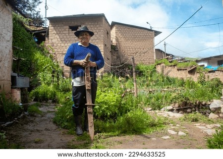 Indigenous farmer holding the chaquitaclla, ancestral tool of the Incas in Huarochirí