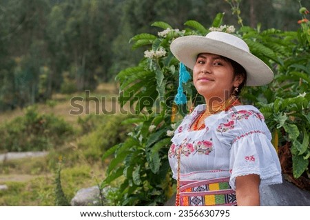 indigenous girl from otavalo, ecuador in traditional dress smiling on the mountain .hispanic heritage month