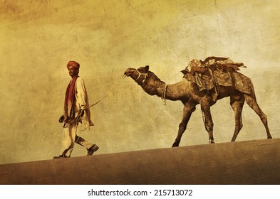 Indigenous Indian man walking through the desert with his camel.