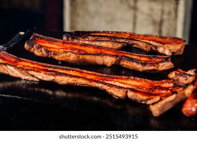 the Indigenous Stone-Grilled BBQ in Dadong night market Tainan taiwan, done by Taiwan's Indigenous peoples, involves grilling marinated meats such as pork or sausages on hot stone slabs. - Powered by Shutterstock