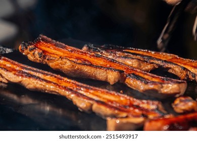 the Indigenous Stone-Grilled BBQ in Dadong night market Tainan taiwan, done by Taiwan's Indigenous peoples, involves grilling marinated meats such as pork or sausages on hot stone slabs. - Powered by Shutterstock