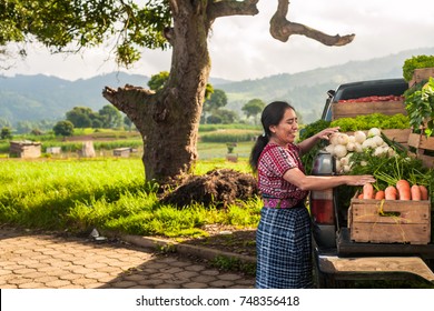 Indigenous Woman With Her Truck Full Of Vegetables In A Rural Area Of Guatemala.