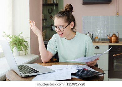 Indignant Angry Irritated Young Woman Looking At Utility Bill, Worried About Troubles With Mortgage Payment To Bank, Having Serious Problems With Debt, Frustrated About High Taxes, 