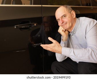 Indignant and angry man when he sees his car door smashed