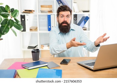 Indignant man complaining while working at work computer in office, indignation.